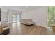 Sunlit living room features hardwood flooring, neutral sofa and sliding glass door to the outside at 3236 Henderson Mill Rd # 1, Chamblee, GA 30341