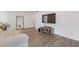 Bright living room with hardwood floors, TV, gray sofa and large mirror that provides ample light at 3236 Henderson Mill Rd # 1, Chamblee, GA 30341