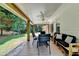 Covered back porch with ample seating and views of the backyard at 5385 Spotted Fawn Ct, Suwanee, GA 30024