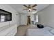 Bright bedroom featuring carpet, ceiling fan, and a large dresser at 5385 Spotted Fawn Ct, Suwanee, GA 30024