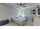 This bedroom has a ceiling fan, carpet, and art that provide a cozy and personalized touch at 5385 Spotted Fawn Ct, Suwanee, GA 30024