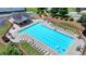 Community pool view with lounge chairs, tables, and a playground at 5385 Spotted Fawn Ct, Suwanee, GA 30024