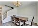 Formal dining room with wainscoting, wood floors, and natural light at 5385 Spotted Fawn Ct, Suwanee, GA 30024