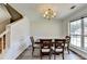 Formal dining room with wainscoting, wood floors, and natural light at 5385 Spotted Fawn Ct, Suwanee, GA 30024