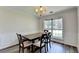 Formal dining room with wainscoting, wood floors, and natural light at 5385 Spotted Fawn Ct, Suwanee, GA 30024
