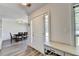 Bright entryway featuring hardwood floors, coat closet, and adjacent dining room at 5385 Spotted Fawn Ct, Suwanee, GA 30024