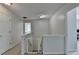 Upstairs hallway with white walls and doors, with a safety gate, and access to bedrooms at 5385 Spotted Fawn Ct, Suwanee, GA 30024