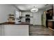 Well-lit kitchen with white cabinets, retro green fridge, and wooden breakfast bar, ideal for quick meals at 5385 Spotted Fawn Ct, Suwanee, GA 30024