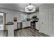 Charming kitchen featuring stainless steel appliances, white cabinets, and a breakfast bar, seamlessly connected to the dining area at 5385 Spotted Fawn Ct, Suwanee, GA 30024