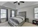 This spacious main bedroom features a tray ceiling, carpet floors, and modern ceiling fan at 5385 Spotted Fawn Ct, Suwanee, GA 30024