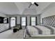 This main bedroom features a tray ceiling, carpet flooring, and large windows for natural light at 5385 Spotted Fawn Ct, Suwanee, GA 30024
