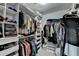This walk-in closet features custom shelving for shoes and plenty of space for hanging clothes at 5385 Spotted Fawn Ct, Suwanee, GA 30024