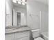 This bathroom has a granite countertop, a soaking tub, and white cabinets at 7238 Crestside Dr, Austell, GA 30168
