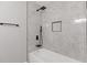 Elegant bathroom showcasing a shower and tub with marble-patterned tile and sleek fixtures at 1272 Sherwood Dr, Norcross, GA 30093