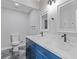 Bathroom featuring dual sinks, modern fixtures, and a blue vanity with marble countertops at 1272 Sherwood Dr, Norcross, GA 30093