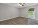 Bedroom features hardwood floors, ceiling fan, window, and neutral color scheme at 1272 Sherwood Dr, Norcross, GA 30093