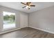 Bedroom features hardwood floors, ceiling fan, double closet doors, and a bright window at 1272 Sherwood Dr, Norcross, GA 30093