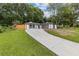Inviting home with a concrete driveway, well-manicured lawn, and a beautifully landscaped yard at 1272 Sherwood Dr, Norcross, GA 30093