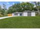 Charming home featuring a blue front door, stylish exterior, and a well-maintained green lawn at 1272 Sherwood Dr, Norcross, GA 30093