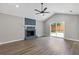 Inviting living room featuring a painted fireplace, ceiling fan, and access to the backyard at 1272 Sherwood Dr, Norcross, GA 30093