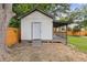 Outbuilding exterior featuring a small porch, a privacy fence, and a mature tree at 1272 Sherwood Dr, Norcross, GA 30093