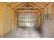 Interior of a small outbuilding with plywood walls, exposed wood supports and built-in shelving at 1272 Sherwood Dr, Norcross, GA 30093