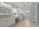 Bright bathroom with double vanities, granite countertops, and a separate shower area at 2845 Echols Road Rd, Cumming, GA 30041