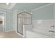 Bright bathroom with a soaking tub, glass shower door, and white tiled walls at 2845 Echols Road Rd, Cumming, GA 30041
