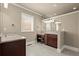 Bright bathroom featuring double sinks with granite countertops, a makeup vanity, and tiled floors at 2845 Echols Road Rd, Cumming, GA 30041