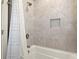Modern bathroom with a tiled shower, convenient built-in niche and a white shower curtain at 2845 Echols Road Rd, Cumming, GA 30041