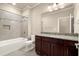 Bathroom with dark wood cabinets, granite countertops, tiled shower over tub and neutral walls at 2845 Echols Road Rd, Cumming, GA 30041