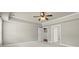Cozy bedroom featuring neutral walls, a ceiling fan and doors leading to bathroom and closet at 2845 Echols Road Rd, Cumming, GA 30041