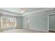 Light-filled bedroom with neutral walls, tray ceiling, large window and doorway to en-suite bath at 2845 Echols Road Rd, Cumming, GA 30041