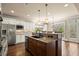 Bright kitchen features an island with granite counters, stainless appliances, and hardwood flooring at 2845 Echols Road Rd, Cumming, GA 30041