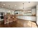 Bright open kitchen with an eat-in island, pendant lighting, white cabinets, and stainless appliances at 2845 Echols Road Rd, Cumming, GA 30041