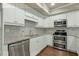 Modern kitchen with stainless steel appliances, granite countertops, and white cabinetry at 2845 Echols Road Rd, Cumming, GA 30041