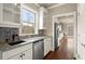 Modern kitchen featuring white cabinetry, granite countertops, stainless steel appliances, and hardwood floors at 2845 Echols Road Rd, Cumming, GA 30041