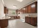 Large laundry room featuring custom cabinetry and granite countertops, with window view at 2845 Echols Road Rd, Cumming, GA 30041