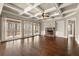 Hardwood flooring in a spacious living room featuring large windows, a fireplace, and built-in shelving at 2845 Echols Road Rd, Cumming, GA 30041