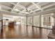 Spacious living room with coffered ceilings, hardwood floors, french doors, and a kitchen view at 2845 Echols Road Rd, Cumming, GA 30041