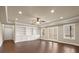 Open living room with hardwood floors, built-in bookshelves, and recessed lighting at 2845 Echols Road Rd, Cumming, GA 30041