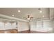 Open living room featuring hardwood floors and a wall of built-in cabinets at 2845 Echols Road Rd, Cumming, GA 30041