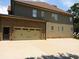 Rear of home with a 2-car garage and driveway, set on a well-manicured lawn at 2845 Echols Road Rd, Cumming, GA 30041