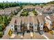 Aerial view showcasing the stunning townhome community surrounded by mature trees and offering scenic city views at 4358 Parkside Pl, Atlanta, GA 30342