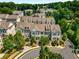 Picturesque aerial shot capturing a townhome community nestled among green trees on a circular street at 4358 Parkside Pl, Atlanta, GA 30342