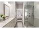 Bathroom with double vanity, walk-in glass shower, and neutral color scheme at 4358 Parkside Pl, Atlanta, GA 30342