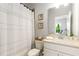 Cozy bathroom showcasing a toilet, framed art, a vanity, and a shower with a decorative curtain at 4358 Parkside Pl, Atlanta, GA 30342