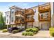 Exterior shot featuring a garage, layered balconies, beautiful landscaping, and a private driveway at 4358 Parkside Pl, Atlanta, GA 30342