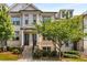 Beautiful townhome with traditional brick facade, manicured landscaping, and inviting entrance at 4358 Parkside Pl, Atlanta, GA 30342