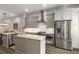 Modern kitchen with gray cabinets, stainless steel appliances, and a center island at 4358 Parkside Pl, Atlanta, GA 30342